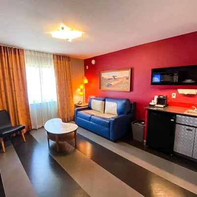 Living Room with Sofa Bed and Kitchenette in Cars Family Suite at Disney's Art of Animation Resort